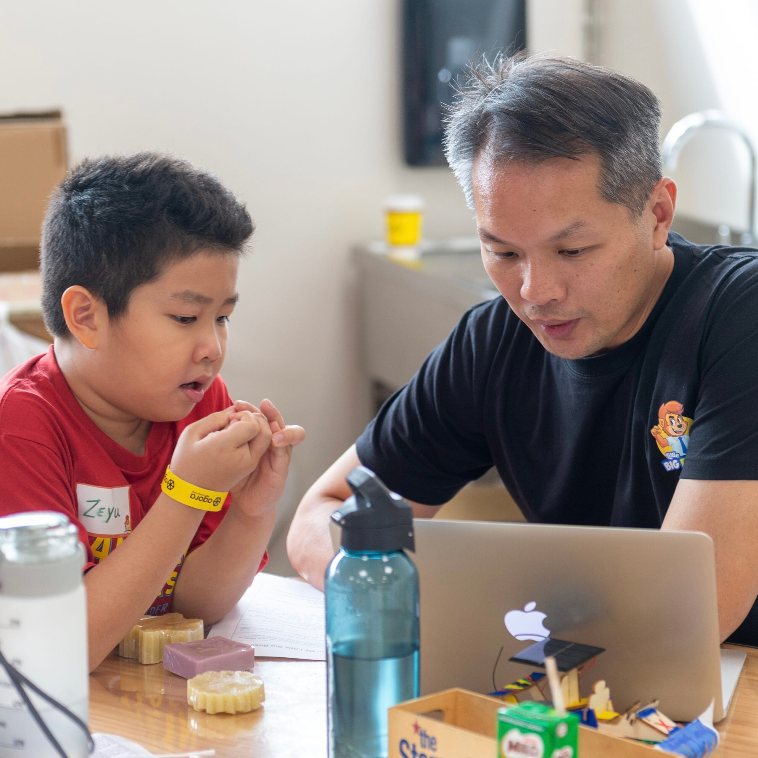 Mentor guiding child through digital learning